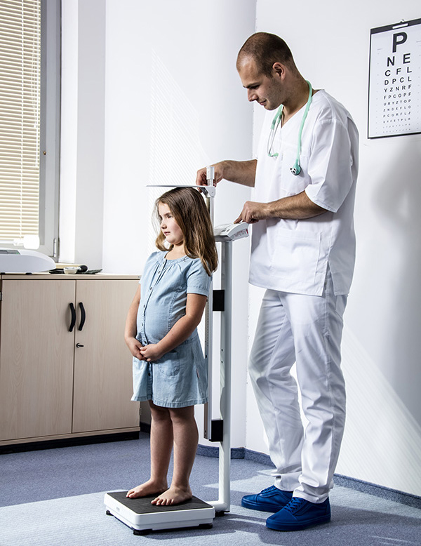 Physician conducting height measurement